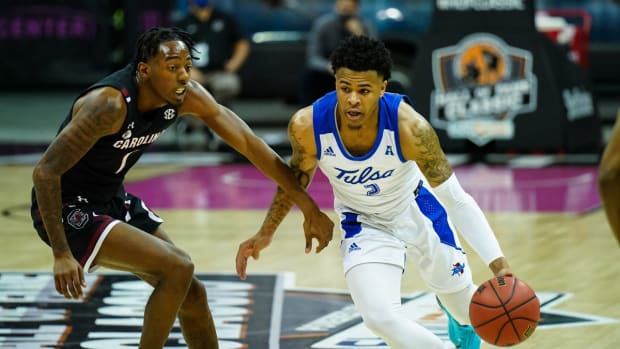 Nov 29, 2020; Kansas City, MO, USA; Tulsa Golden Hurricane guard Elijah Joiner (3) drives against South Carolina Gamecocks guard TJ Moss (1) during the second half at T-Mobile Center. Mandatory Credit: Jay Biggerstaff-USA TODAY Sports